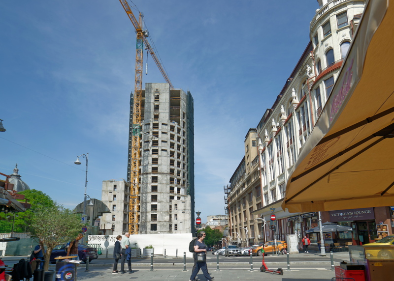 Urban scene in Bucharest, Romania, featuring a significant construction site in the center
